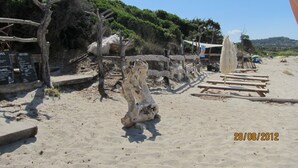 A sandy beach with wooden structures and a rustic fence. - Fantastic apartment with sea views in prime location (Santa Reparata di Balagne)