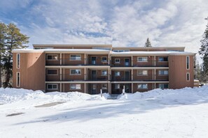 Un immeuble à plusieurs étages doté d’une façade symétrique, de grandes fenêtres et de balcons.