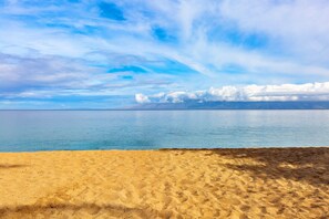 A beach with a clear sky and calm sea.