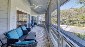 A covered porch with wicker furniture and a ceiling fan. - Updated & Open, Sea Woods Veranda. Walking Distance to Beach - SV227 (New Smyrna Beach)