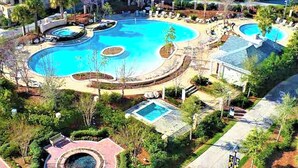 A resort with multiple swimming pools, landscaped gardens, and a central fountain. - Enjoy your very own private courtyard! FREE TRAM ! Mins. to pool,dining,shopping (MIRAMAR BEACH)