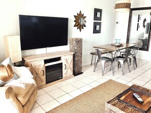 Relax in this stylish living room with a flat-screen TV, fireplace, and comfortable seating area.