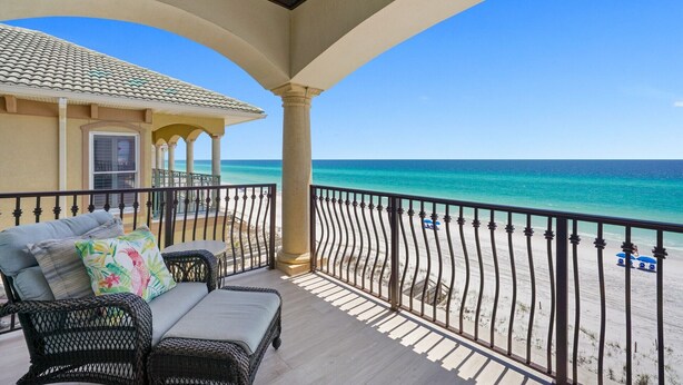 A balcony with wicker furniture and a view of the beach. - SEA HIS LOVE: Destiny's Gulf Front Luxury Retreat: Infinity Pool, Elevator, Daily Maid Service! (Destin)