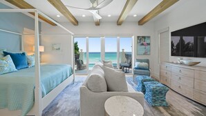 A spacious bedroom with a large bed, a sofa, and a dining area. - SEA HIS LOVE: Destiny's Gulf Front Luxury Retreat: Infinity Pool, Elevator, Daily Maid Service! (Destin)