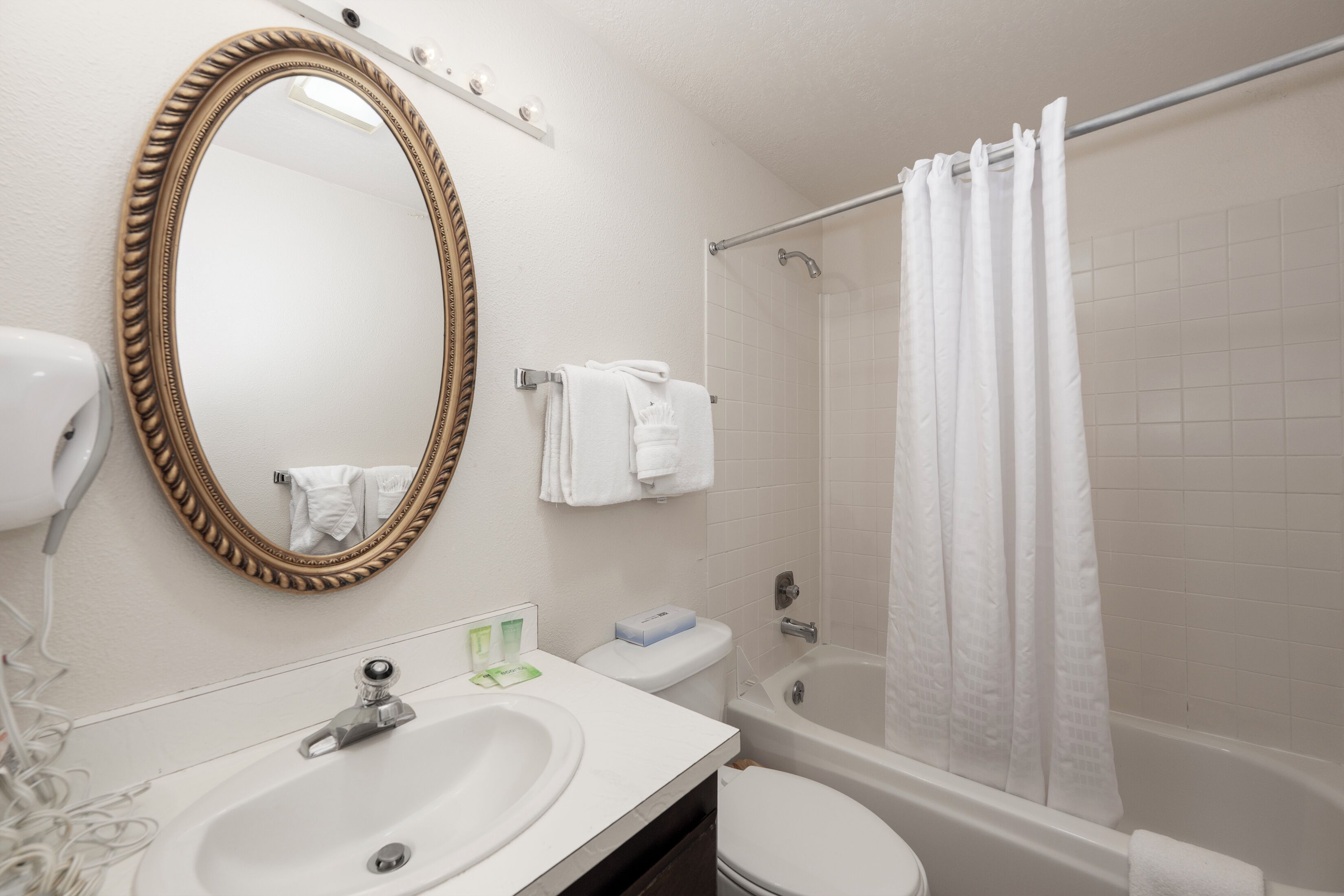 A bathroom with a sink, toilet, and bathtub.