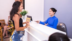 A reception desk with a sign reading "Reception". - Shark Hotel - Hostel (Hue)