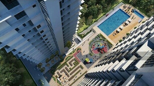 A high-rise building with a pool area, including a circular fountain and lounge chairs. - Sekinchan Seaview Homestay (Sekinchan)