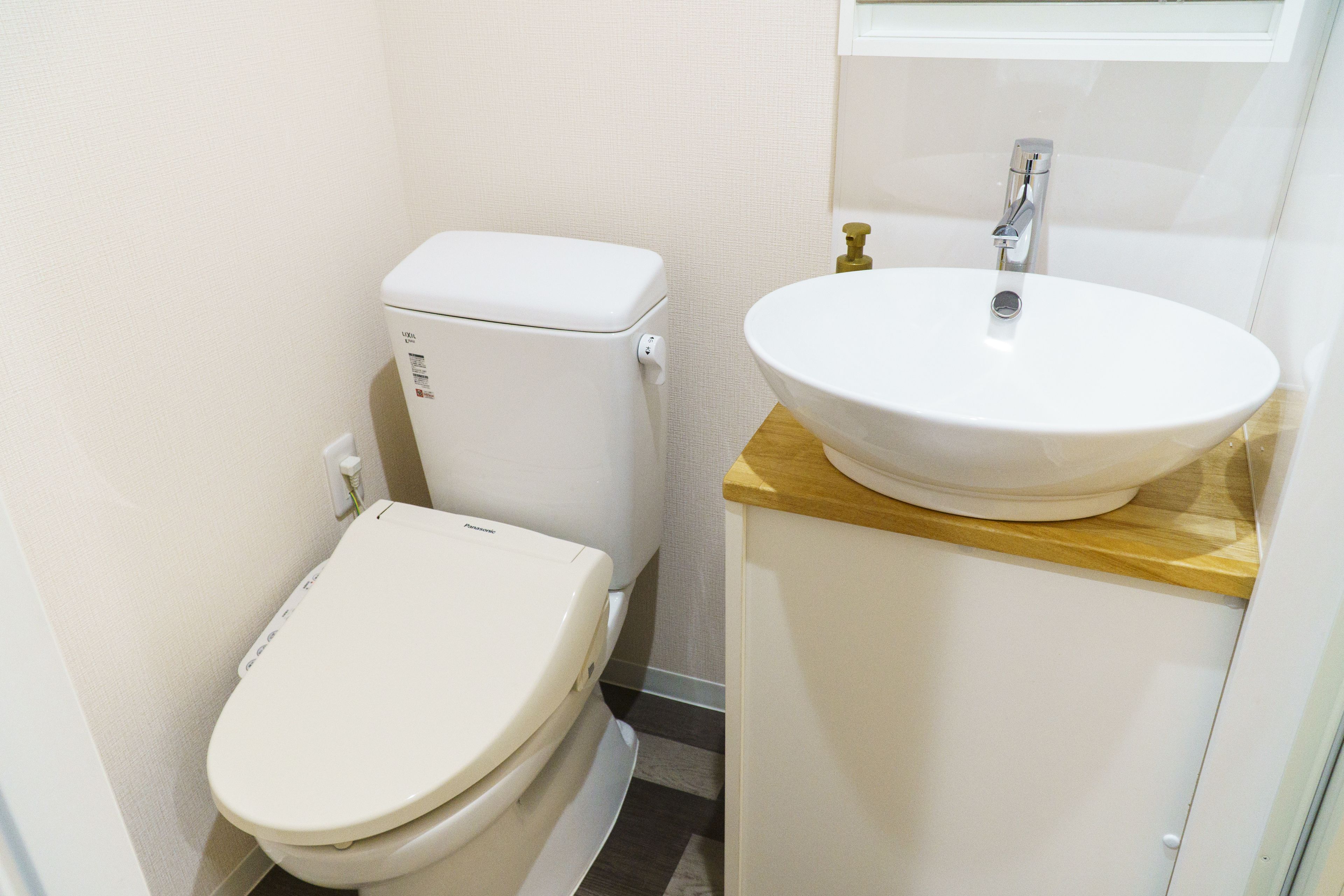 A small bathroom with a toilet and a sink.
