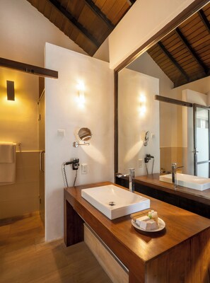A modern bathroom with a large mirror, wooden vanity, and a shower area. - Grand Beach Hotel Wadduwa (Wadduwa)