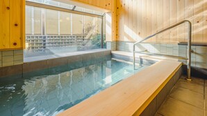A wooden interior with a swimming pool, a window, and a metal handrail. - Asahiya (Himi)