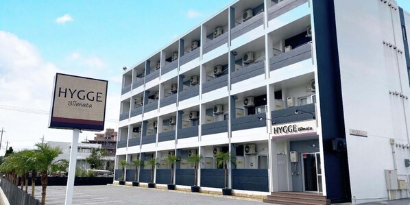 A multi-story building with a sign reading "HYGGE Blimata". - HYGGE Biimata (Nago)
