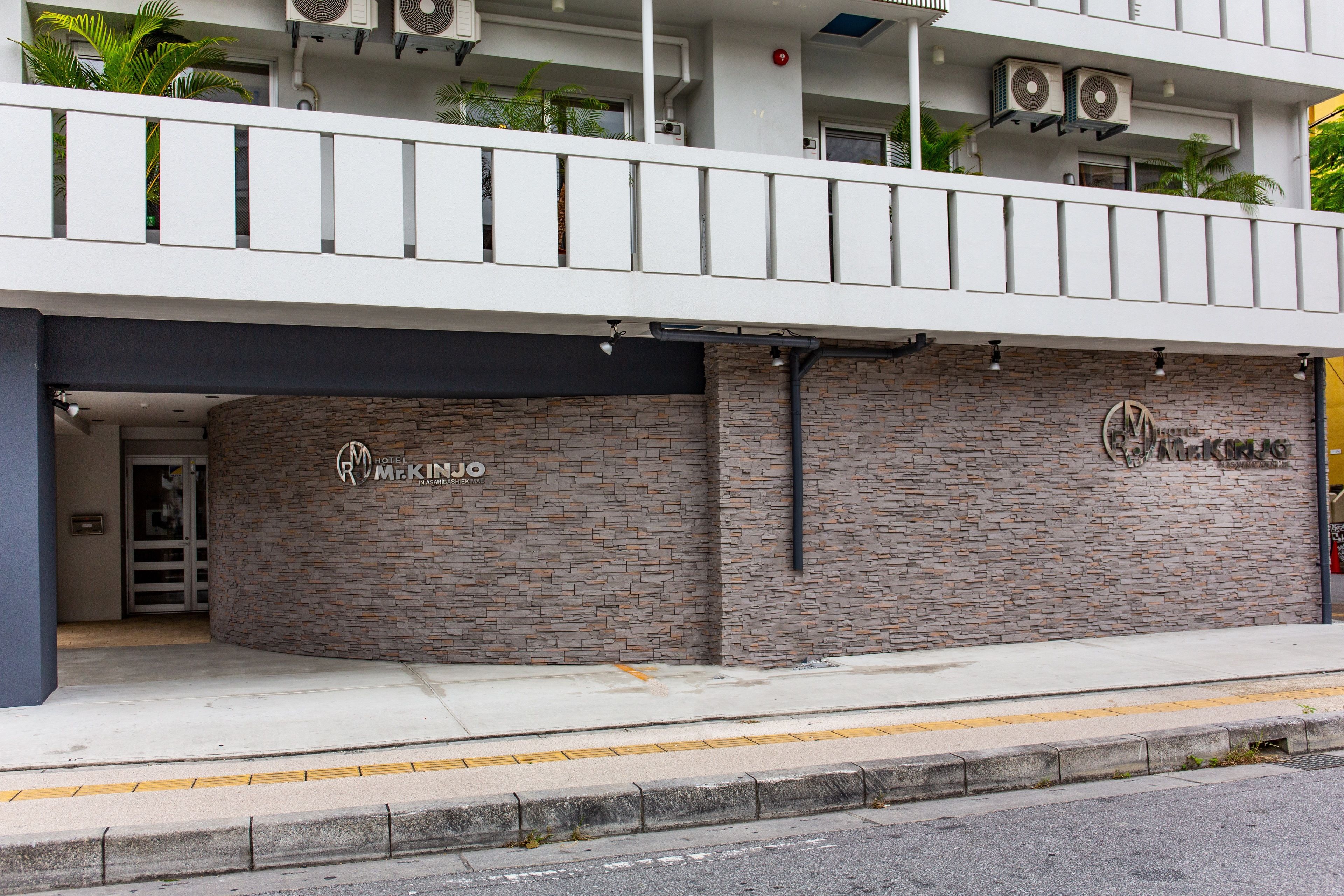 Un edificio con facciata in pietra e un cartello con su scritto "Motel McKinjo".