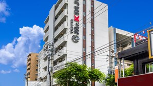 A multi-story hotel with a prominent logo, balconies, and a clear blue sky. - Mr.KINJO in Asahibashi station square (Naha)