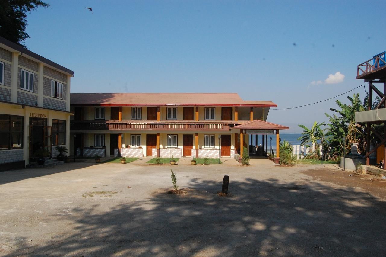 A two-story building with a reception area, multiple rooms, and a balcony.