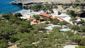 A coastal property with multiple buildings, a beach, and rocky terrain. - Amazing Stone villa (Gortyna)