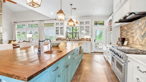 A spacious kitchen with a large island, white cabinetry, and a herringbone-patterned backsplash. - 4BR Canyon Lake Retreat with New Private Pool & Outdoor Living (Canyon Lake)