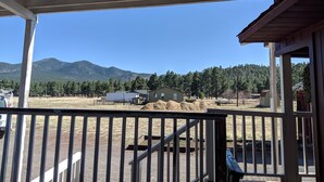 A covered outdoor area with a view of mountains and trees. - Near town & Golf, Sleeps 15, 3,300sqft, 1.9 Acres, 6BR w/4Kings, Game Room, HVAC (Williams)