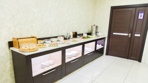 A buffet setup with various food items and a coffee station. - Magistral (Urtaaul)