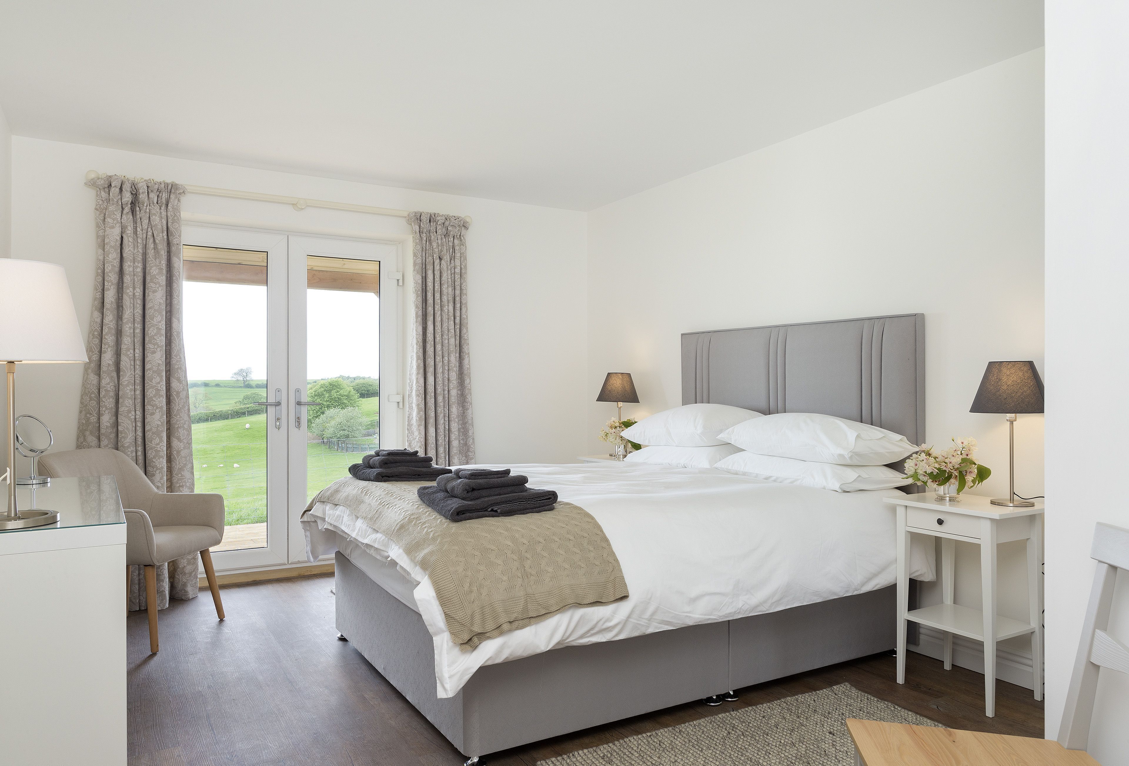 Ground floor: Bedroom with king size bed and en-suite bathroom with shower, and french doors to veranda