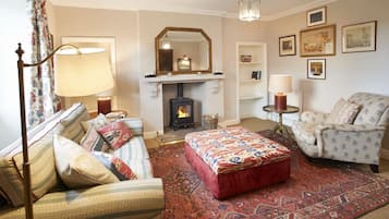 Ground Floor: Sitting room with wood burning stove and furnished with carefully chosen pieces from Castle Howard itself