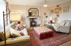 Ground Floor: Sitting room with wood burning stove and furnished with carefully chosen pieces from Castle Howard itself