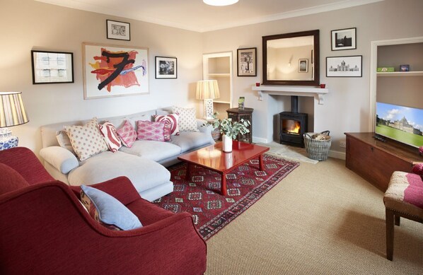 Ground Floor: Snug/TV room with wood burning stove, relax on the comfortable L-shaped sofa