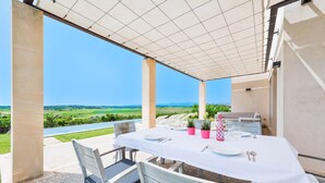 An outdoor patio with a table set for dining, overlooking a scenic landscape. - CAN SAL - Villa with private pool in and free WiFi in Ariany (Ariany)