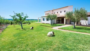 A two-story house with a white facade and terracotta roof tiles, surrounded by a well-maintained lawn and trees. - CAN SAL - Villa with private pool in and free WiFi in Ariany (Ariany)