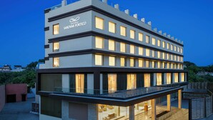 A modern hotel with a flat roof, multiple balconies, and a prominent sign. - Nataraj Sarovar Portico Jhansi (Jhansi)
