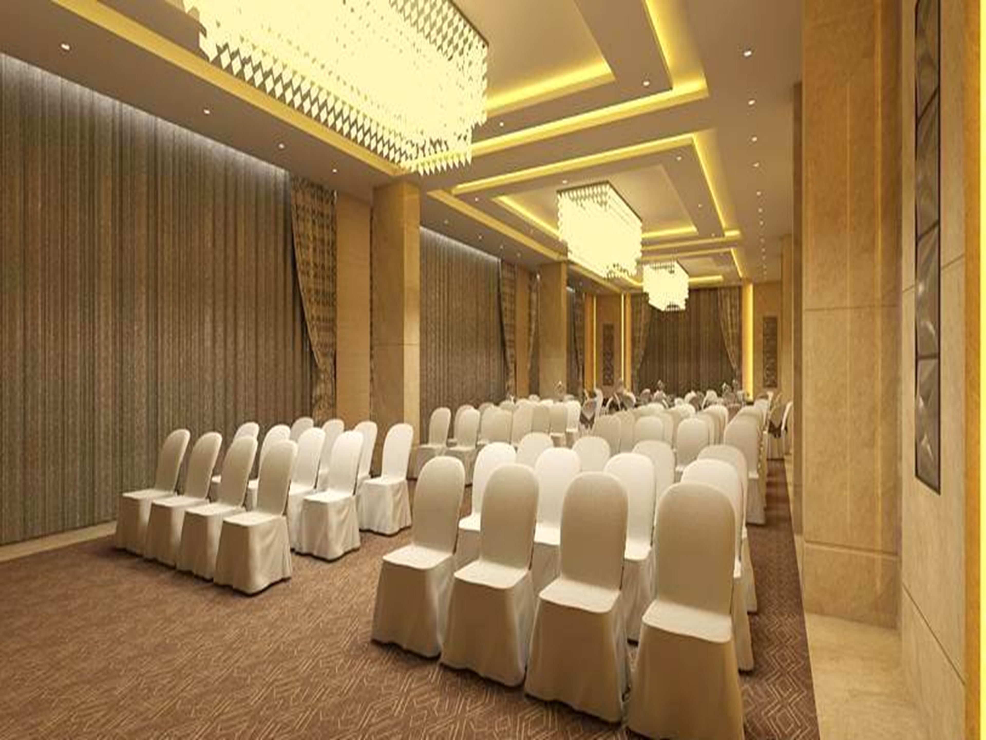 A conference room with rows of white chairs, a patterned carpet, and a chandelier.