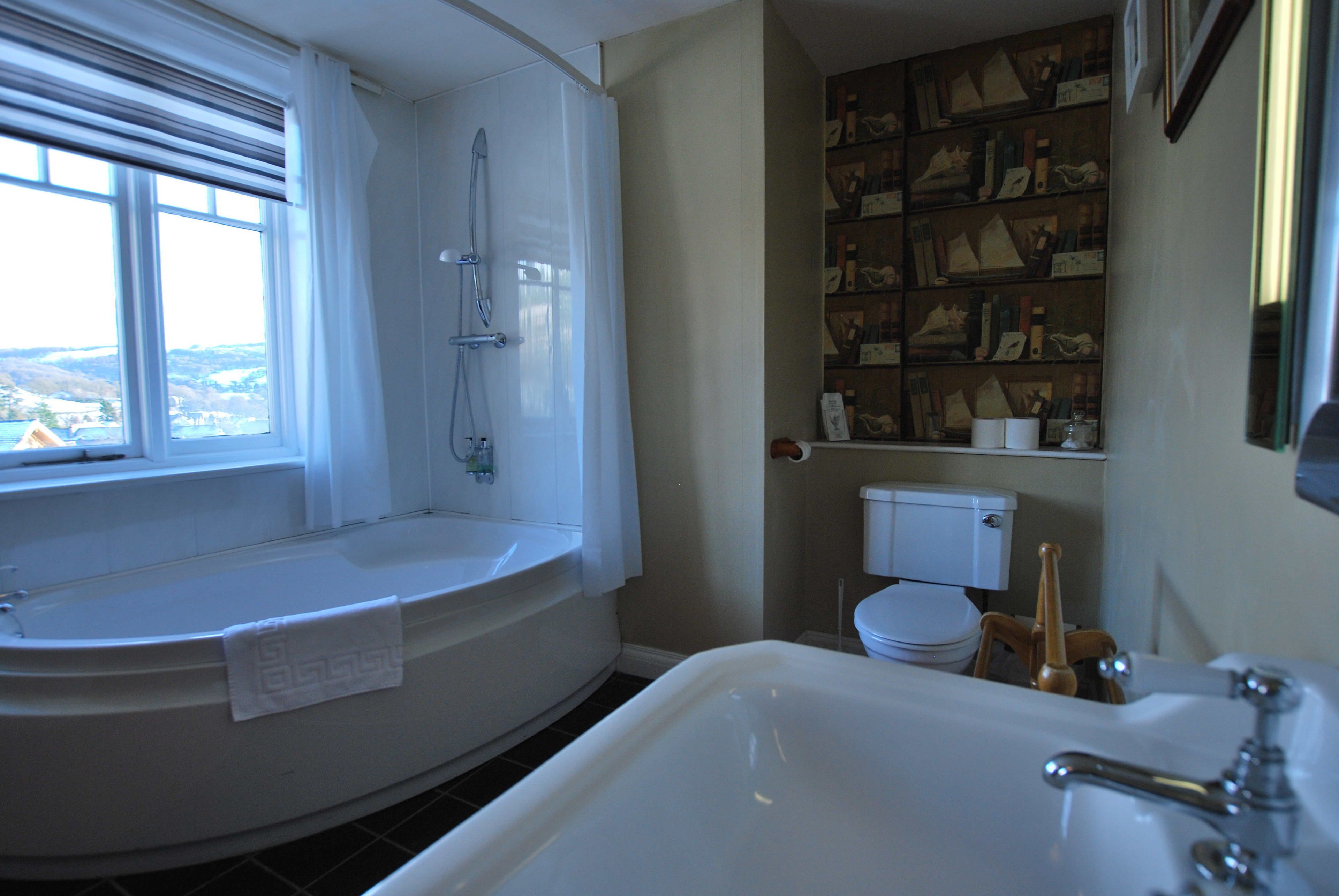 A bathroom with a bathtub, a toilet, and a sink.