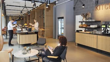 Een moderne keuken met houten kastjes, een aanrecht en een hanglamp.