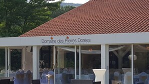 A restaurant named Domaine des Pierres Dorées with outdoor seating and a red-tiled roof. - Domaine des Pierres Dorées (Ternand)