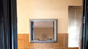 A bathroom with a white sink, dark wooden cabinet, and a mirror above it. - Four Seasons Guesthouses (Lephalale)