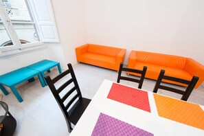 Basic Apartment, 4 Bedrooms | Living area | Flat-screen TV