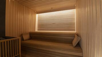 A wooden sauna with a bench and a window.