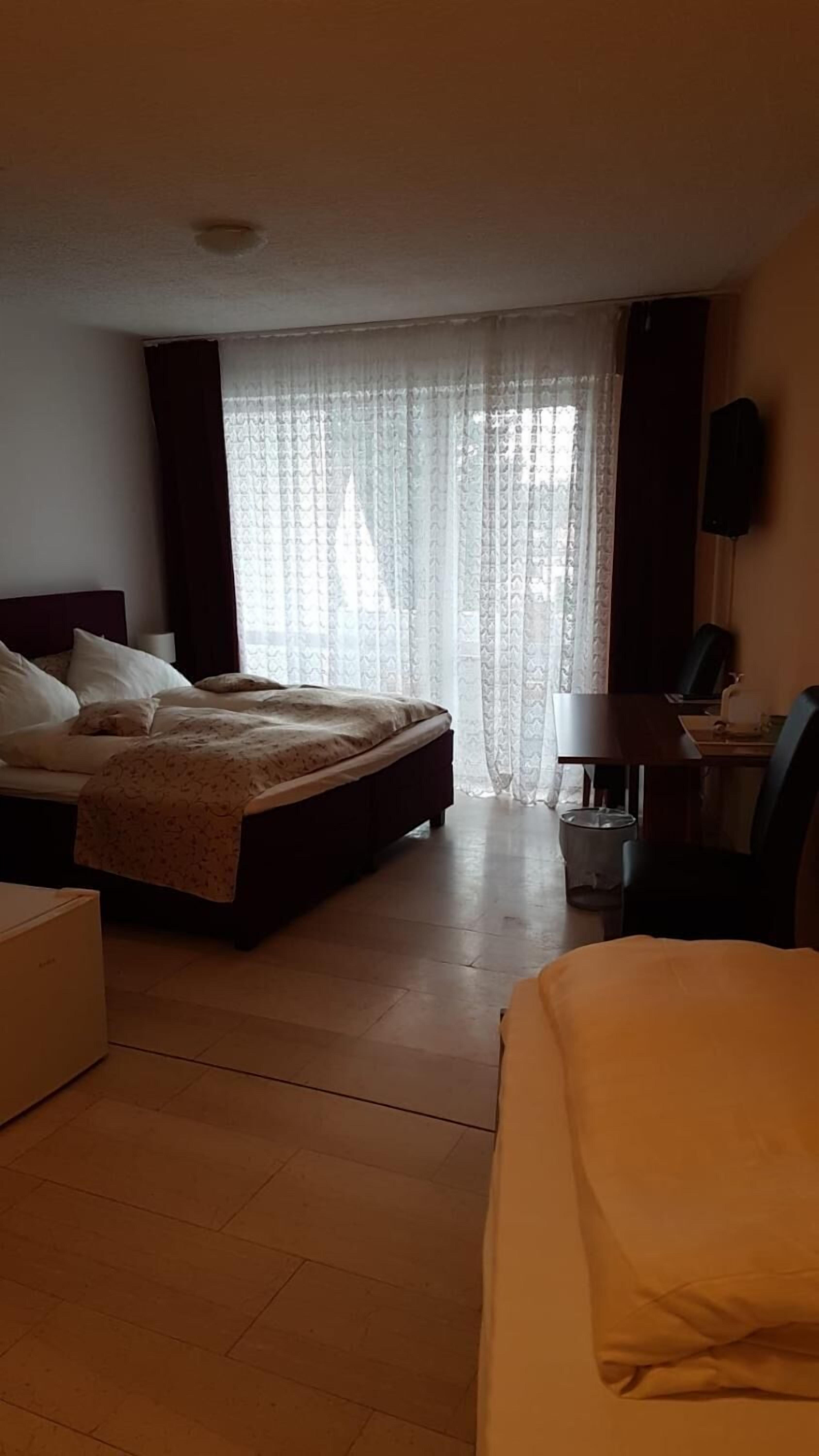 Ein Hotelzimmer mit einem Bett, einem Schreibtisch und einem Sessel.