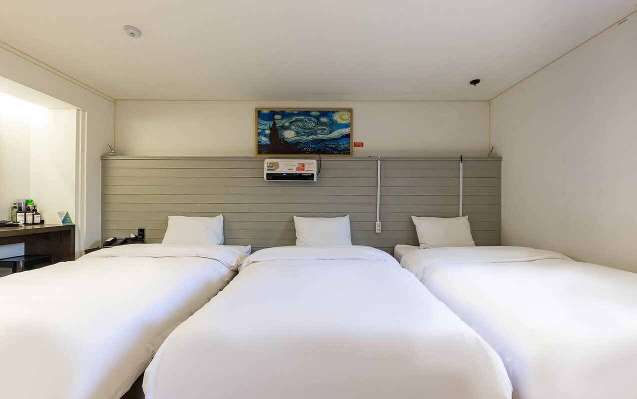 business triple room | premium bedding, down duvets, desk, laptop workspace