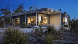 A modern, two-story house with large glass windows, a flat roof, and a minimalist design. - Aplite House (Friendly Beaches)