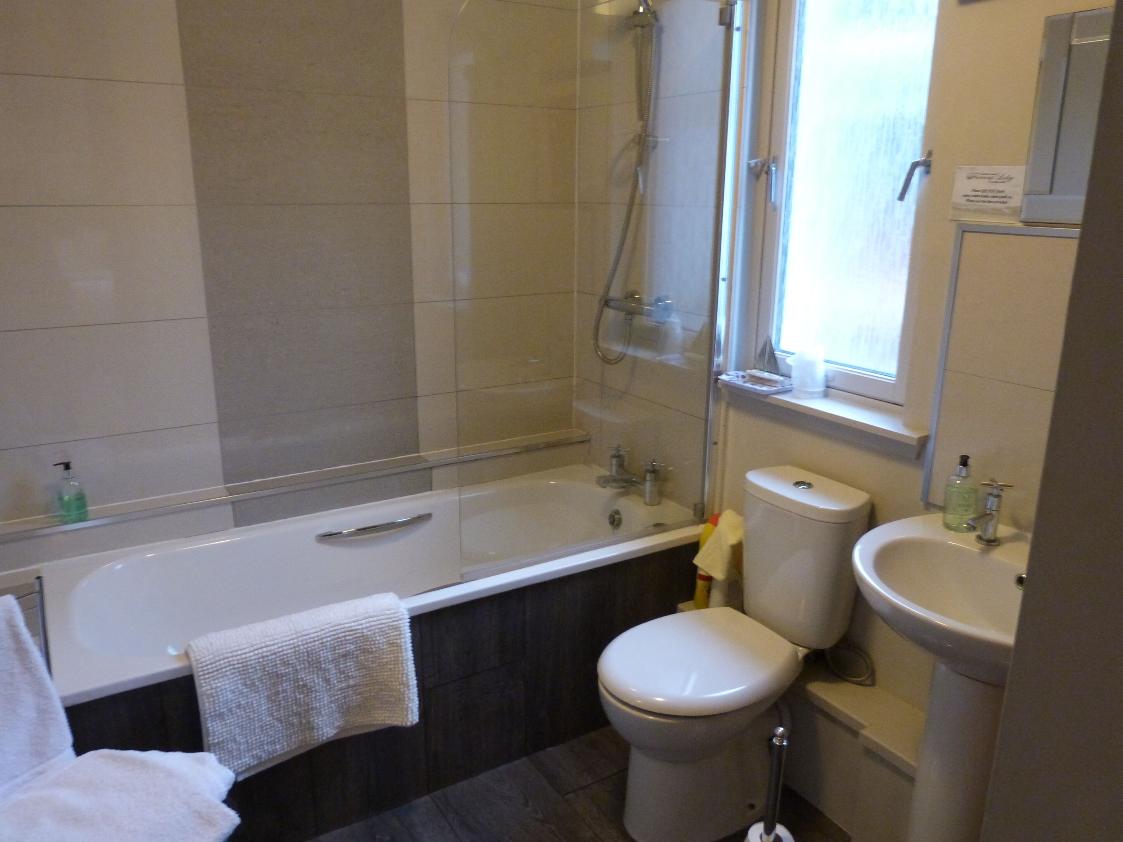 A modern bathroom with a bathtub, toilet, and sink.