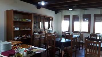 A dining area with wooden furniture and a buffet setup.