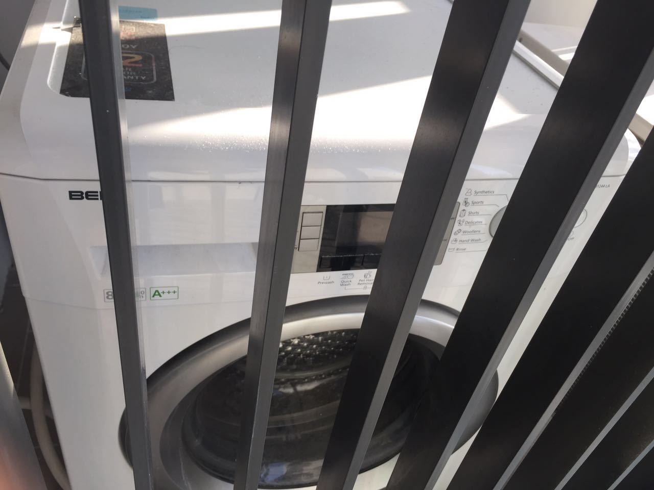 A front view of a washing machine with a control panel and a label indicating 'A+++' rating.