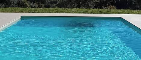 Seasonal outdoor pool, open 9:00 AM to 7:00 PM, pool umbrellas