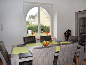 Enjoy meals in this dining area with a table for four, surrounded by a large window offering a view of the outdoors.
