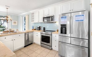 Enjoy cooking in this well-equipped kitchen with a refrigerator, microwave, and dishwasher.