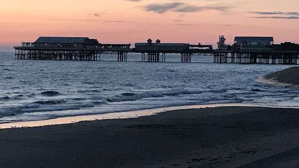 A pier extending into the water with buildings at the end. - Belmont Hotel Blackpool (Blackpool)
