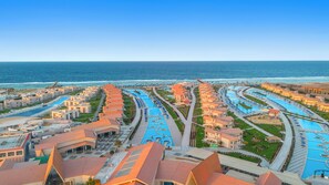 A resort with multiple swimming pools, beachfront villas, and a view of the ocean. - Pickalbatros Sea World Resort - Marsa Alam- "Aqua Park" - All inclusive (El Quseir)