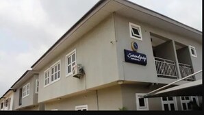 A building with a sign reading "Serendipity Inn Hotel." - Serendipity Anchotel (Lagos)