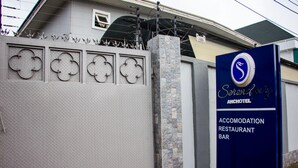 A sign for Serenity Anchotel, indicating it offers accommodation, a restaurant, and a bar. - Serendipity Anchotel (Lagos)