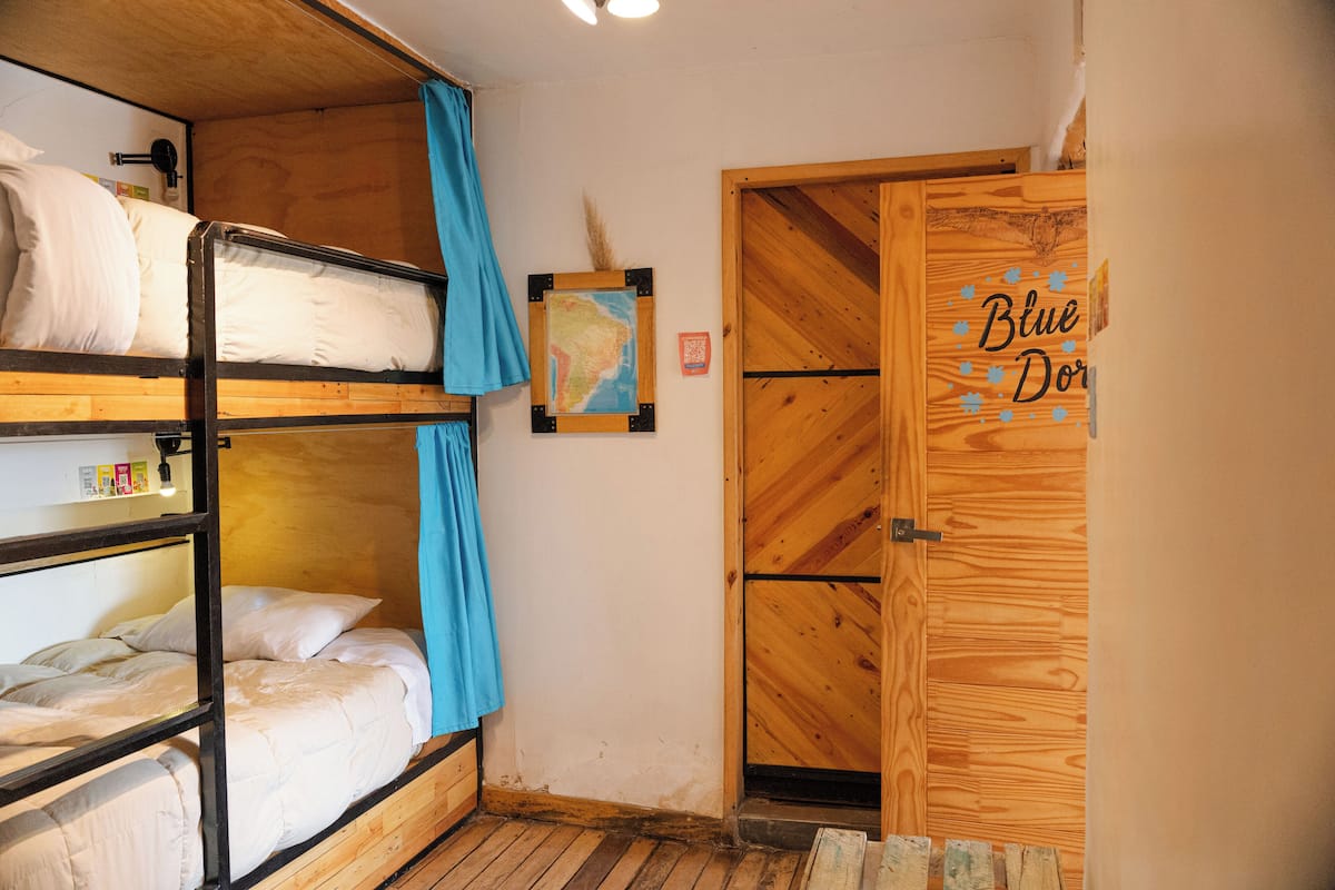 A bunk bed room with a wooden door labeled "Blue Door".